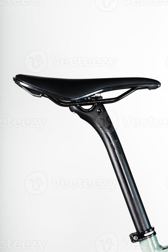 Bicycle saddle with seatpost on a light background accessories for bike repair and tuning photo