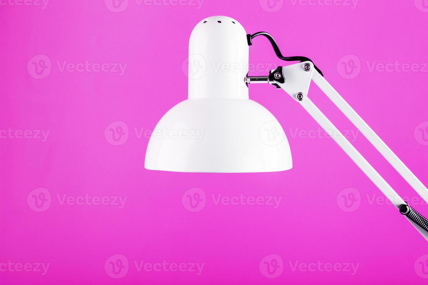 White table office lamp on pink background with space for text and idea concept photo