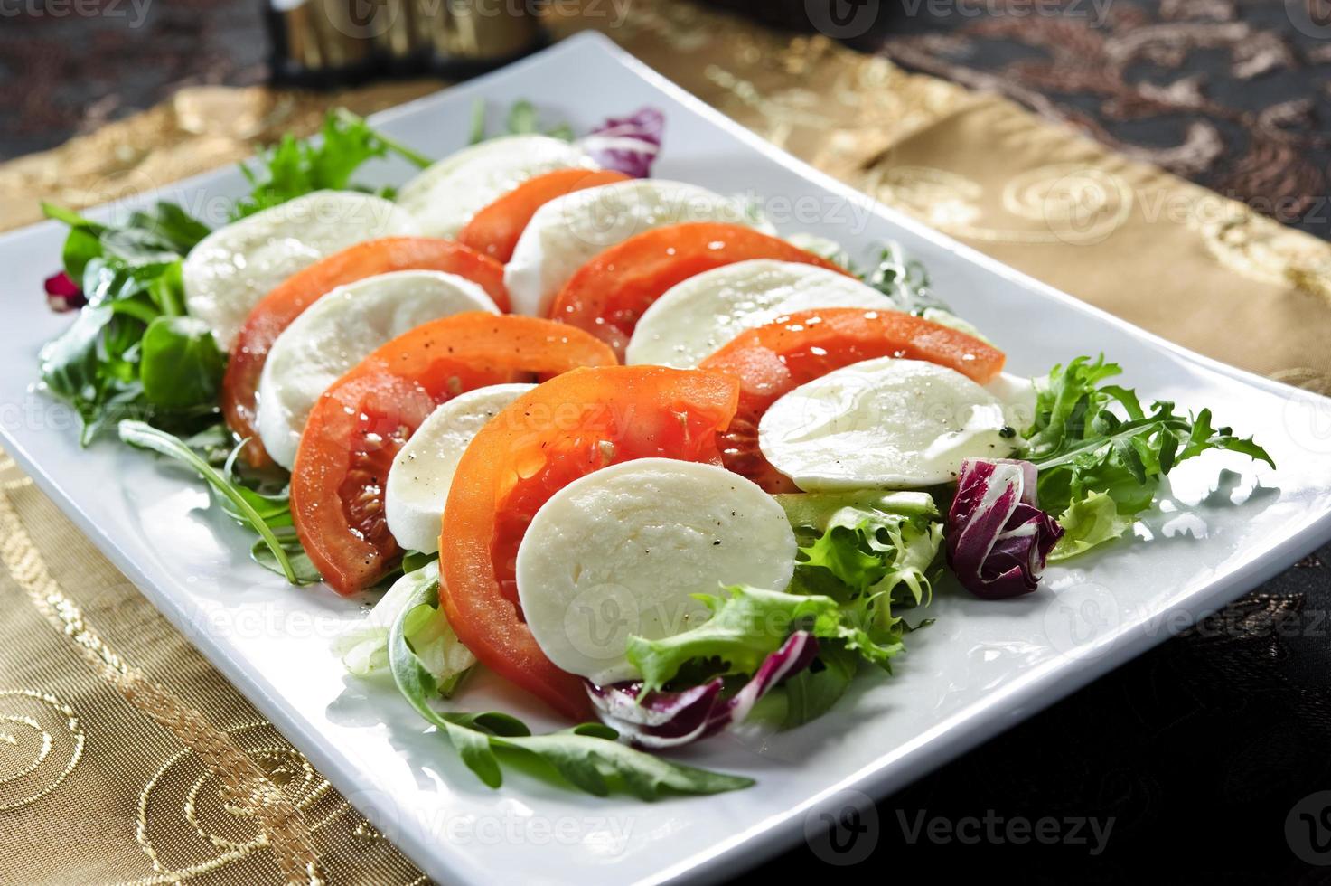 Plate of tomato,mozzarella and basil. photo