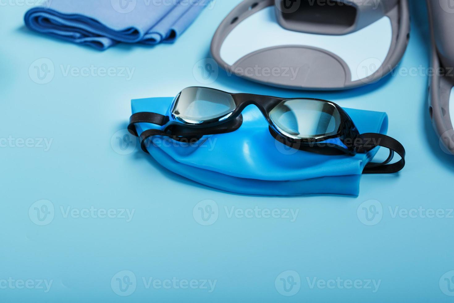 Sports equipment for swimming in the pool and open water on a blue background photo