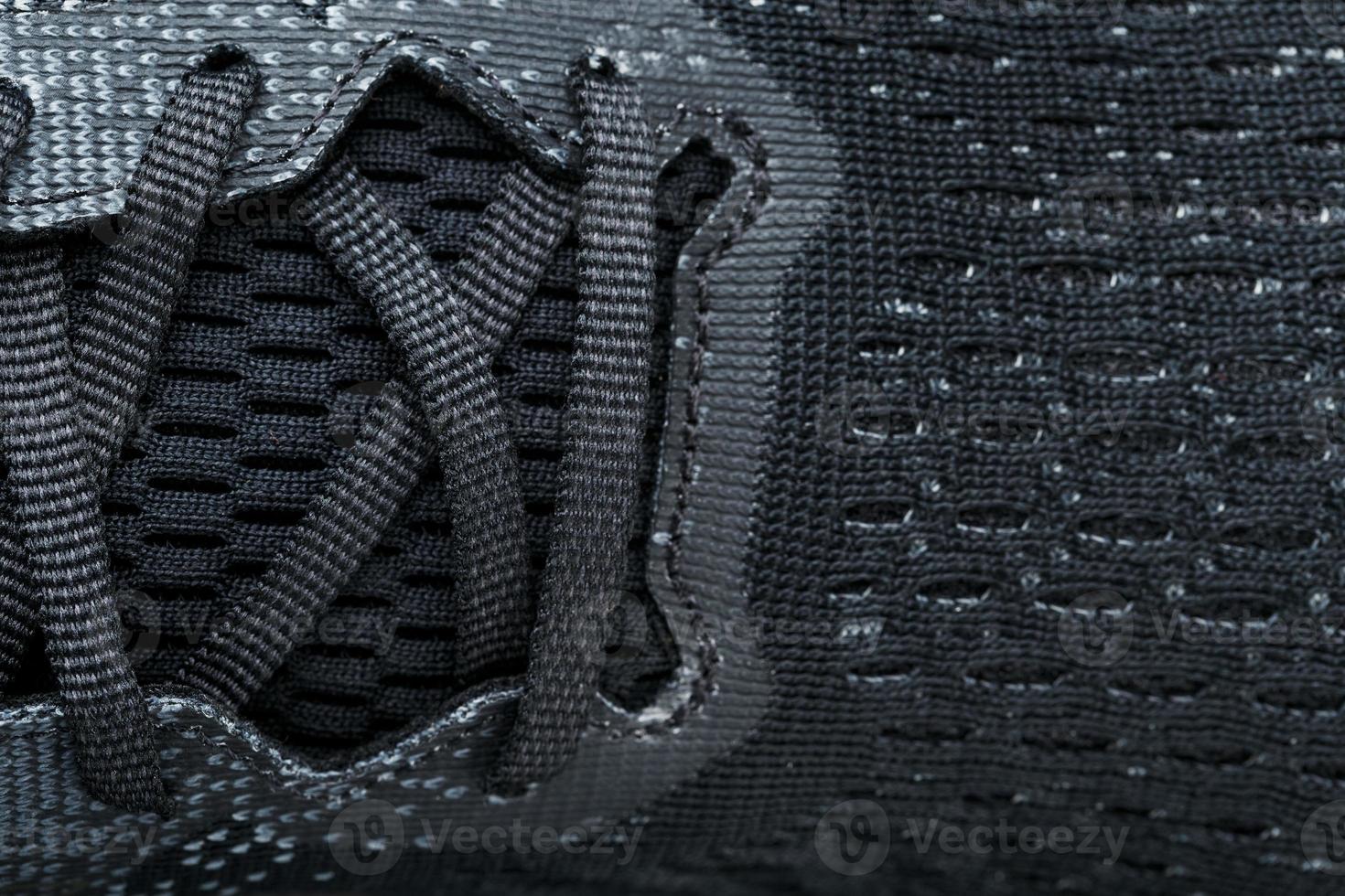 Mesh of black sports sneakers for training Macro photo