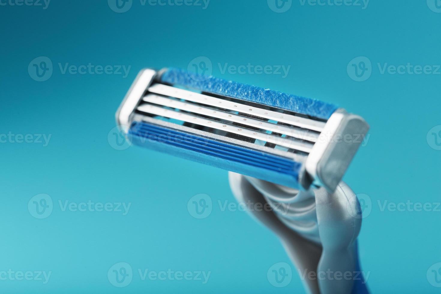 Shaving machine with three blades on a blue background close-up free space photo