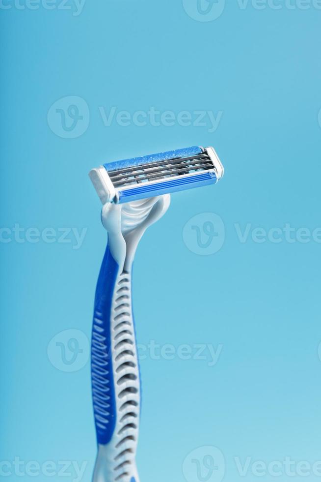 Shaving machine with three blades on a blue background close-up free space photo