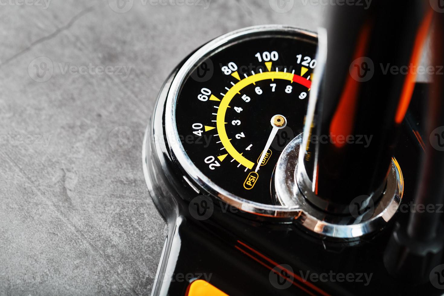 Air pump with a manometer and a wheel inflation hose on a dark background with free space photo