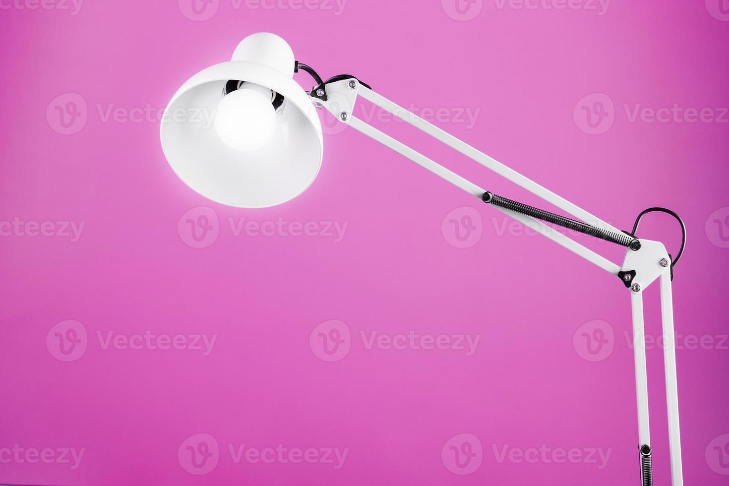 Classic table lamp on pink background with space for text and idea concept photo