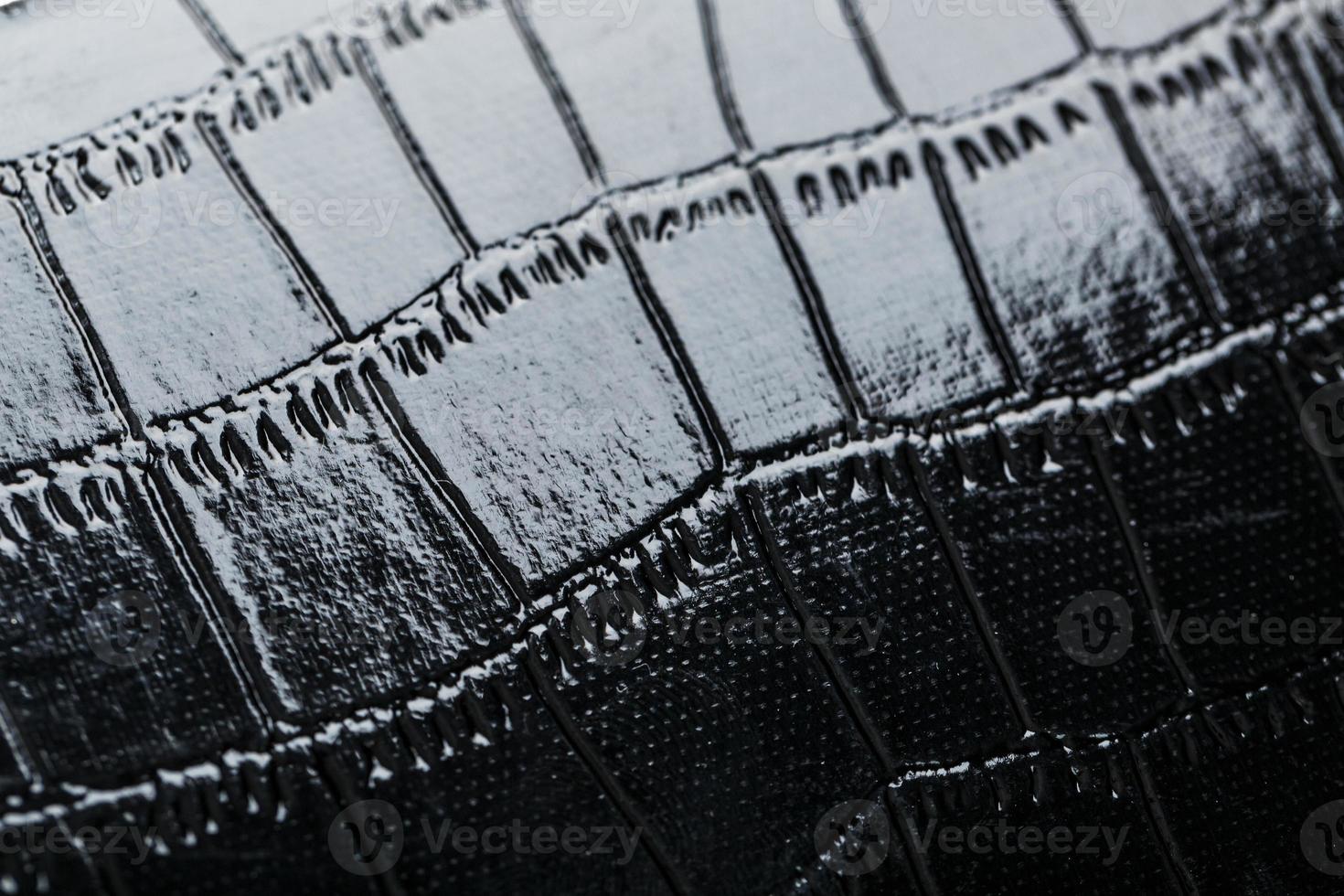 Texture of black crocodile skin in the background in full screen photo