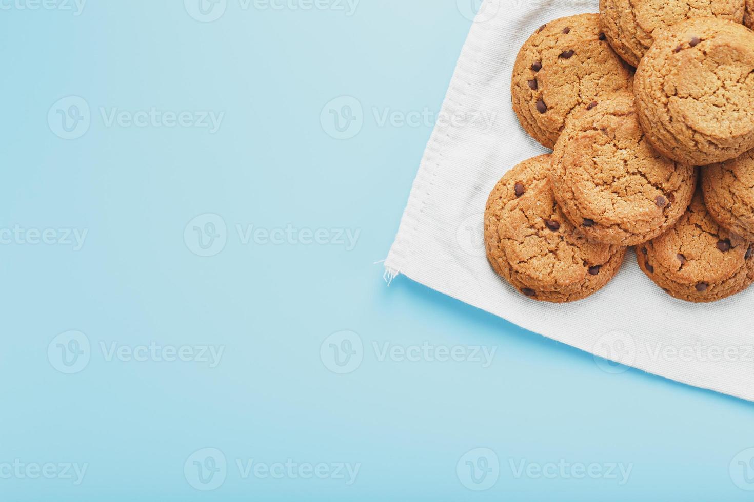 Oatmeal cookies on a napkin on a blue background photo