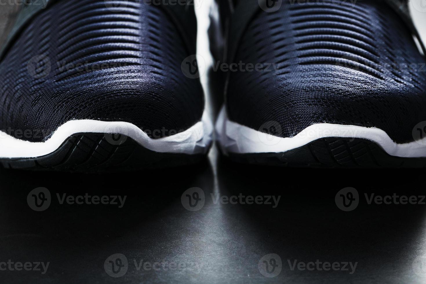 Black and white ultra-modern sports sneakers on a black background. photo