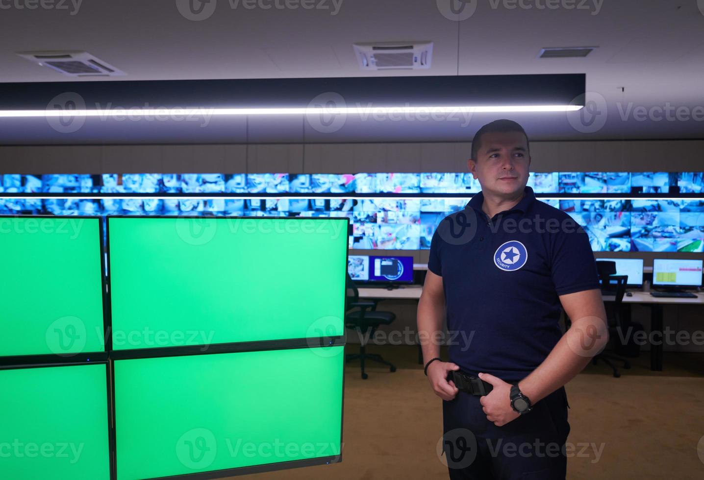 portrait of young male security operator in a data system control room photo