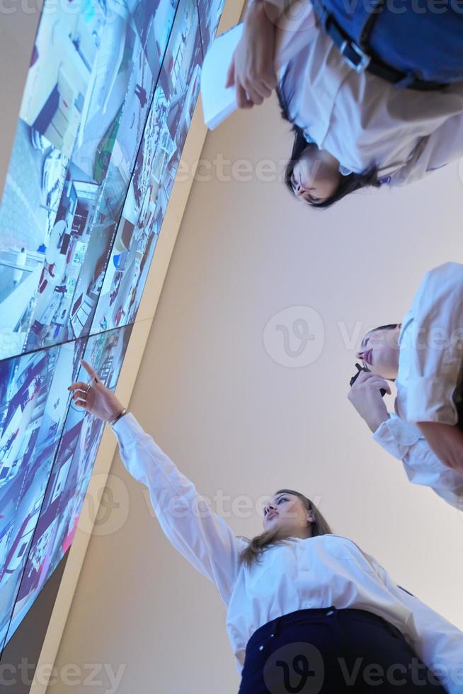 Female security guards working in a security data system control room photo