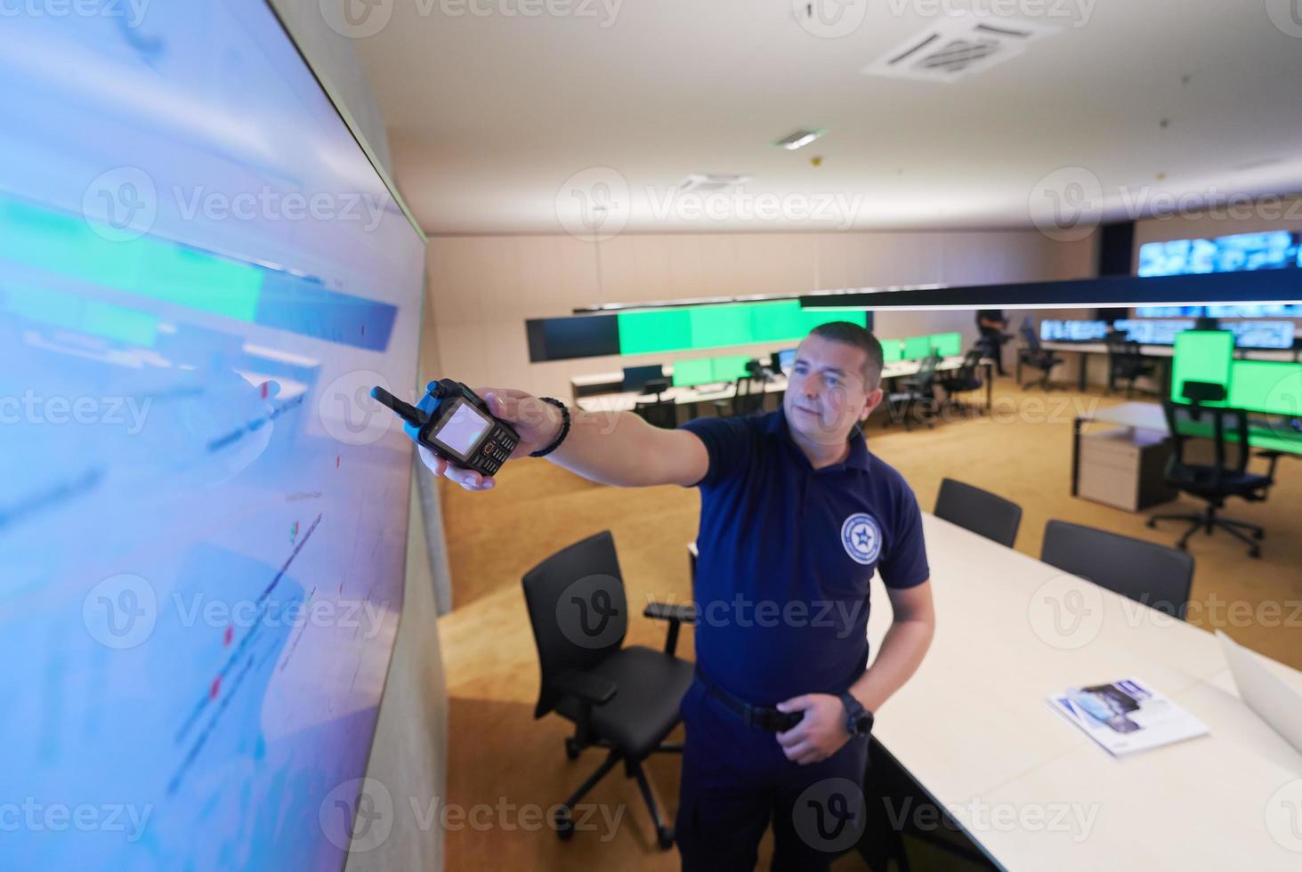 portrait of young male security operator in a data system control room photo