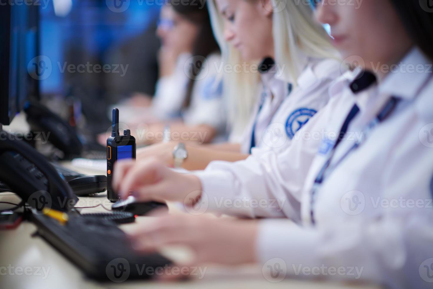 Female security guards working in a security data system control room photo