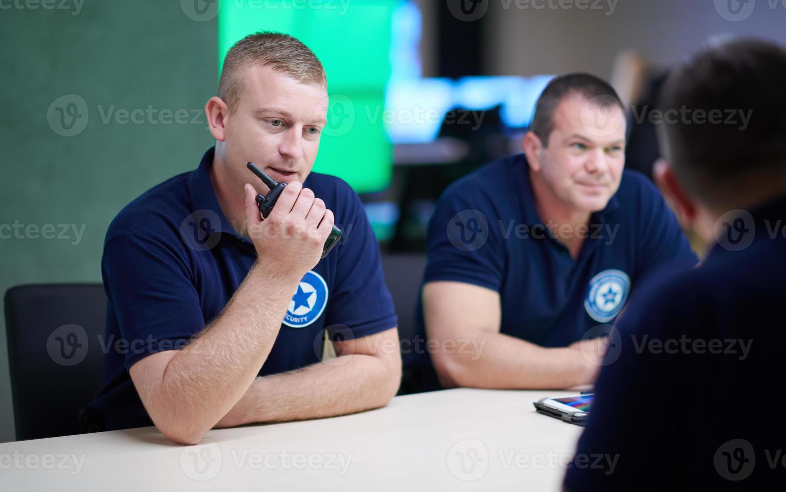 Group of security guards sitting and having briefing photo