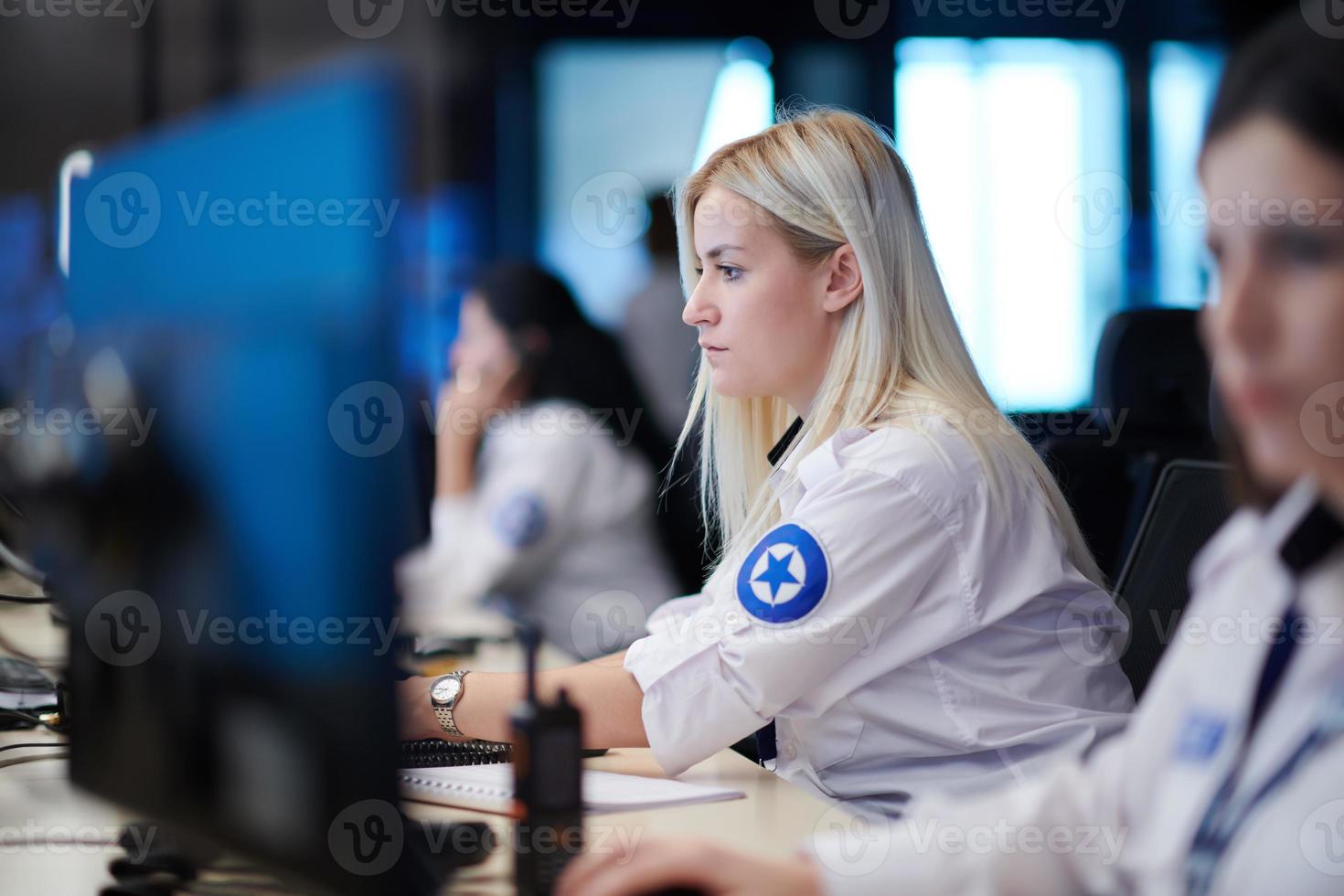 Female operator working in a security data system control room photo