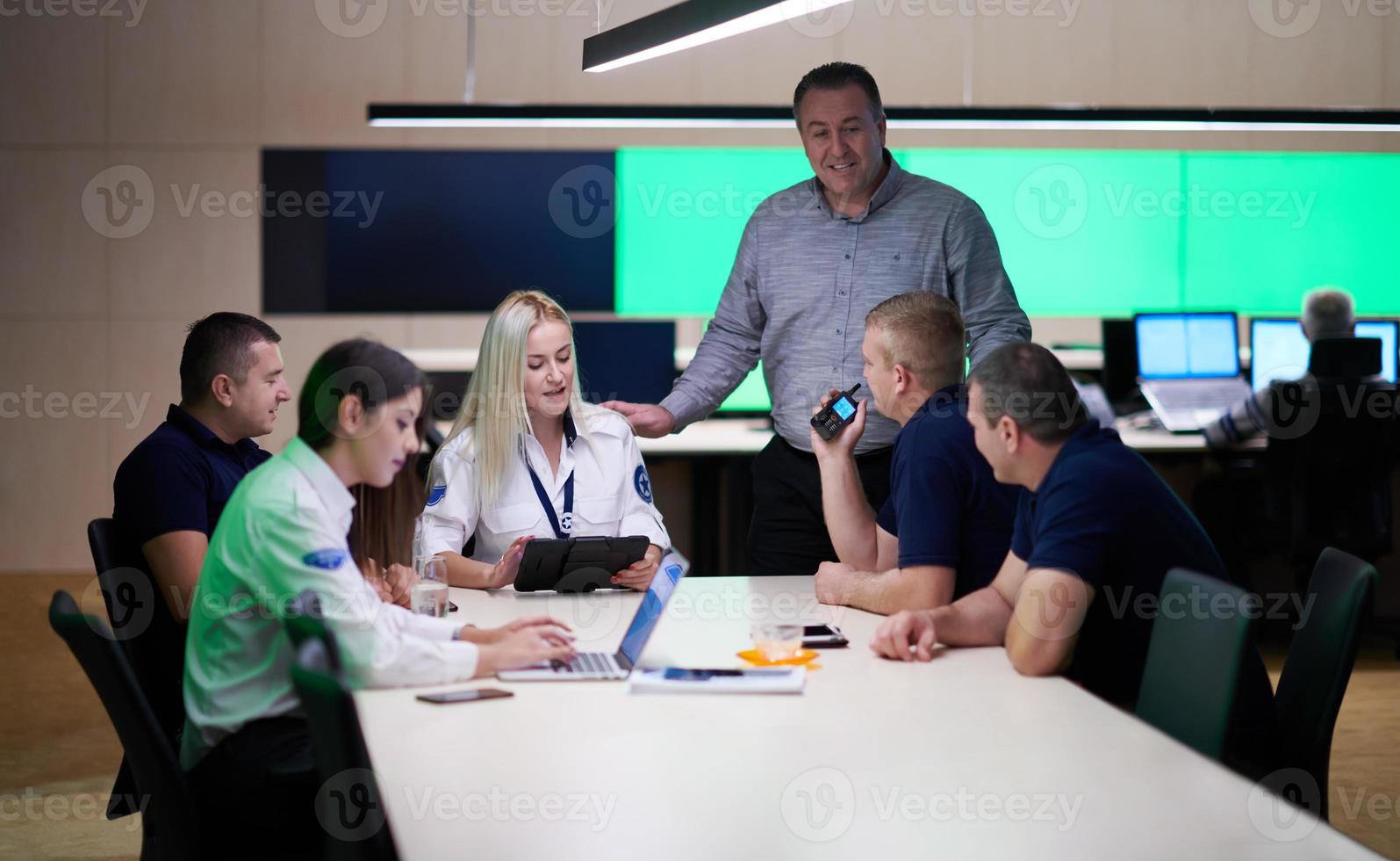 Group of security guards sitting and having briefing photo