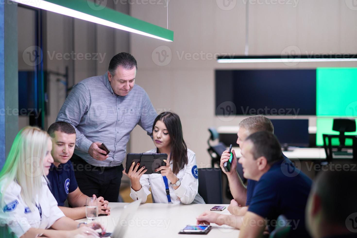 Group of security guards sitting and having briefing photo