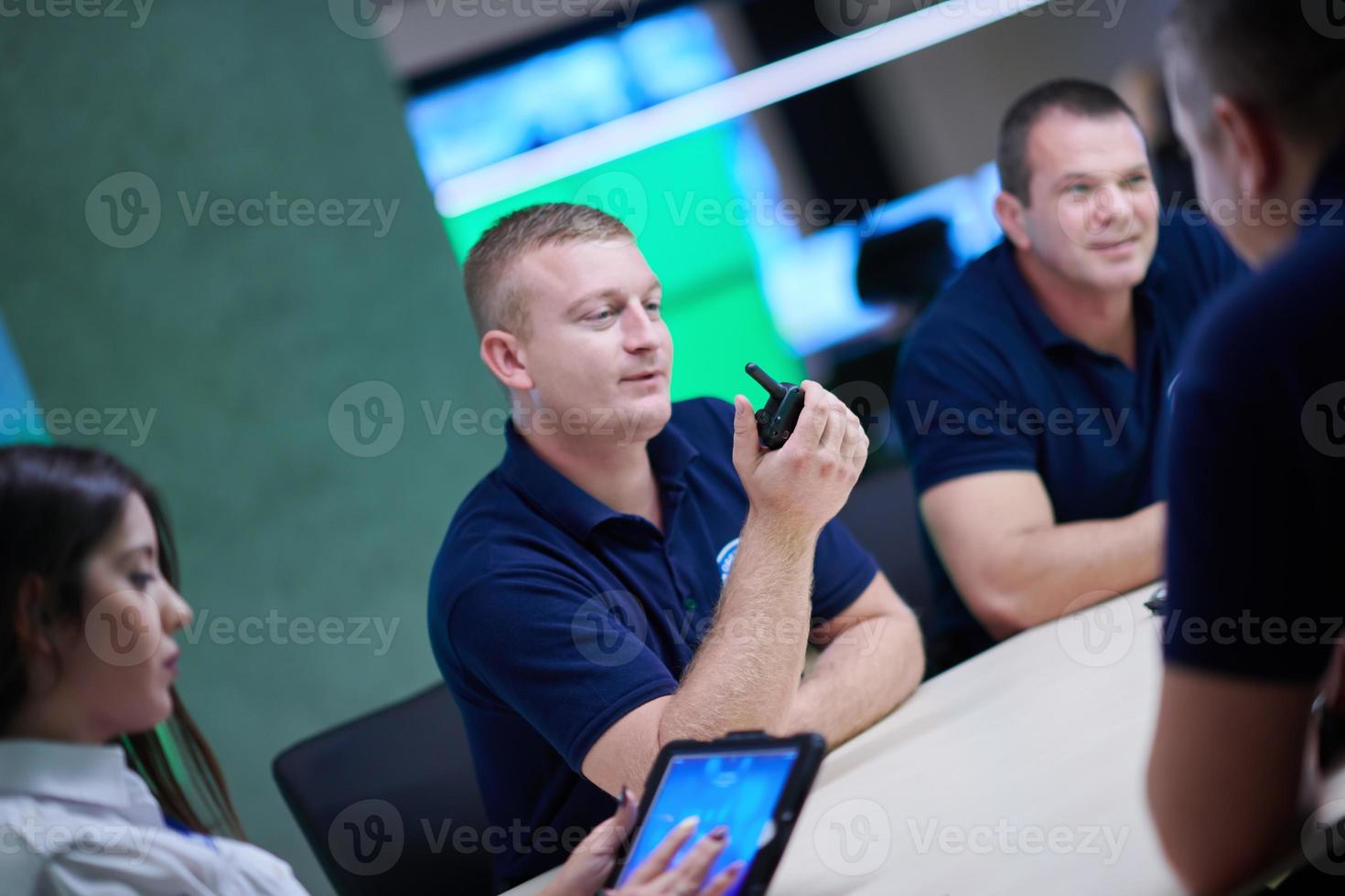 Group of security guards sitting and having briefing photo