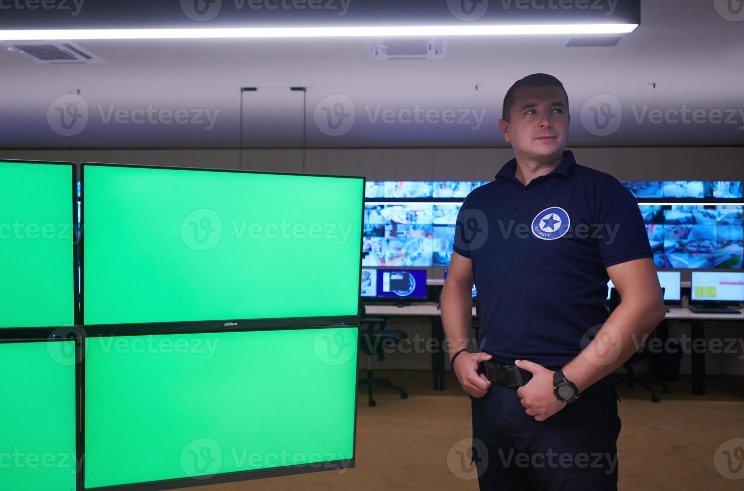 portrait of young male security operator in a data system control room photo