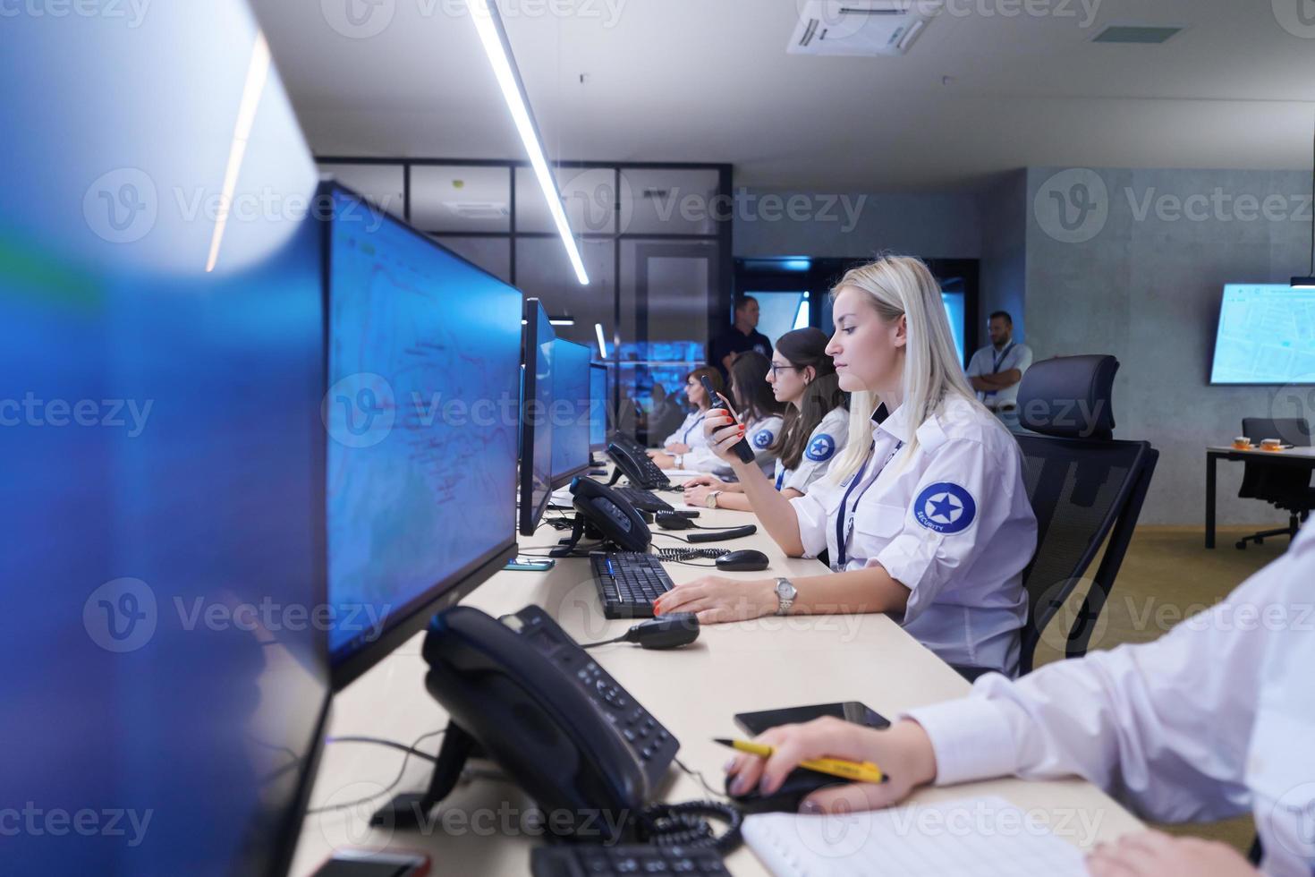 Female security guards working in a security data system control room photo