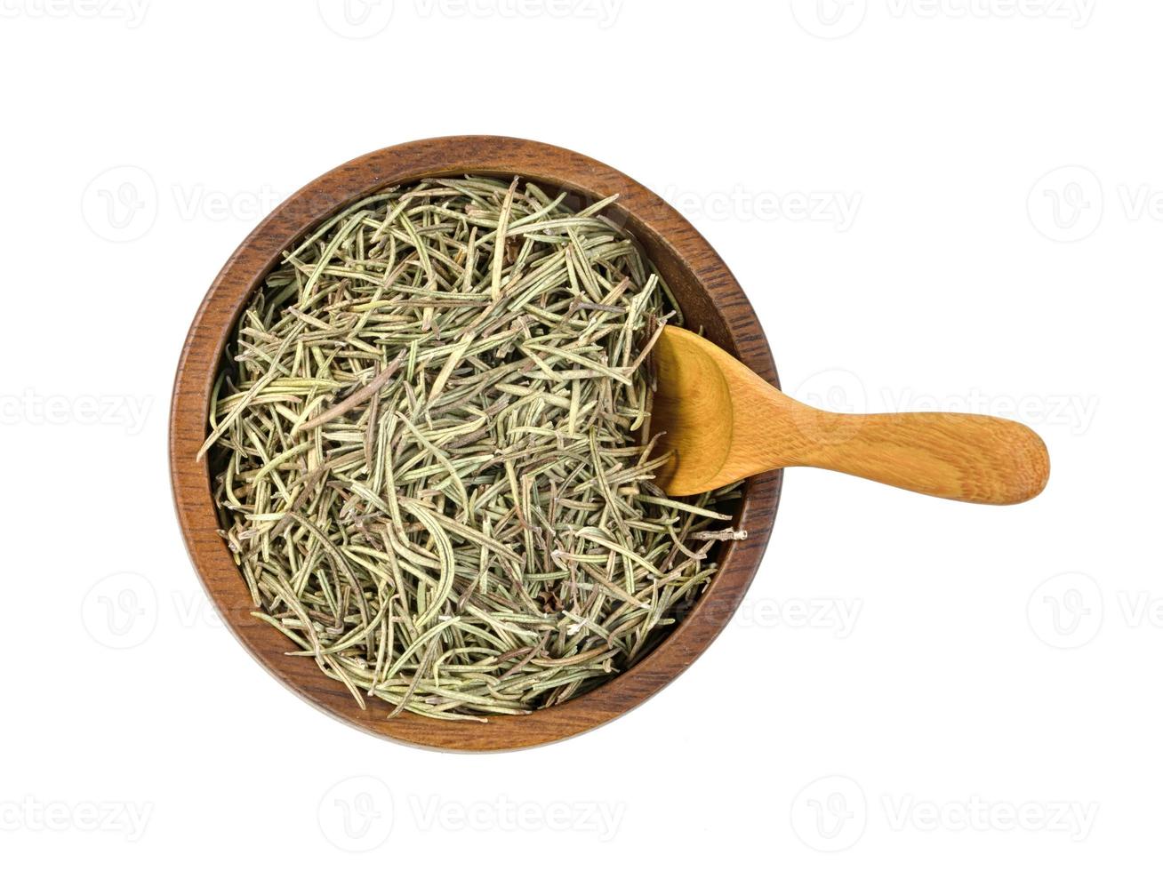 Dry rosemary in wooden bowl and spoon isolated on white background photo