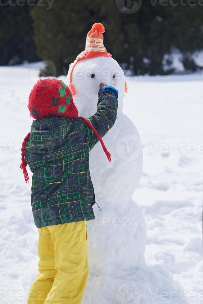 boy making snowman photo