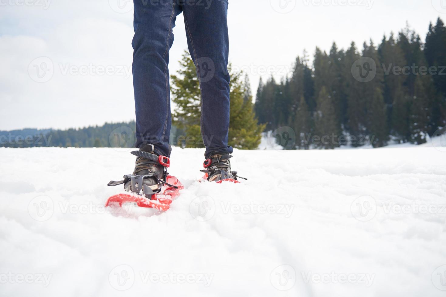 couple having fun and walking in snow shoes photo