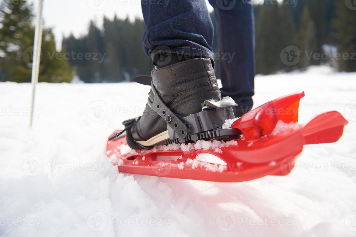 couple having fun and walking in snow shoes photo