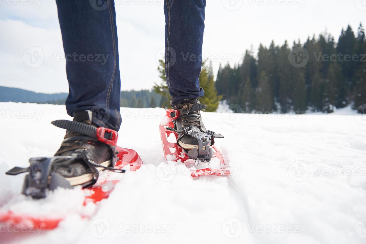 couple having fun and walking in snow shoes photo