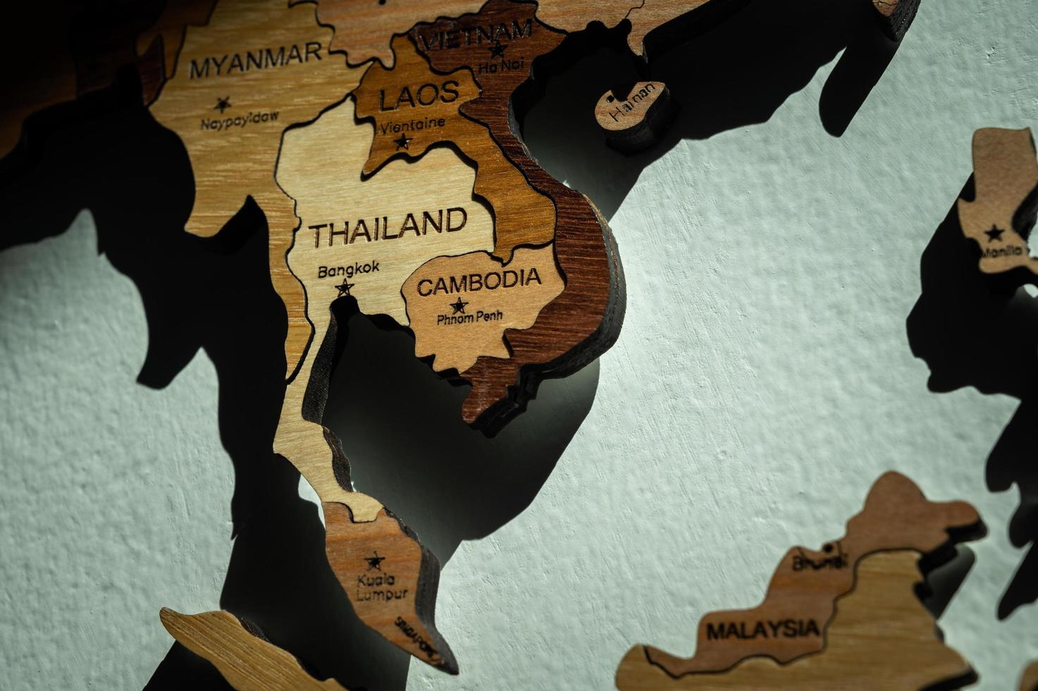 Close up of Southeast Asia countries such as Thailand, Cambodia, Myanmar, Laos etc on wooden world map on the wall. photo