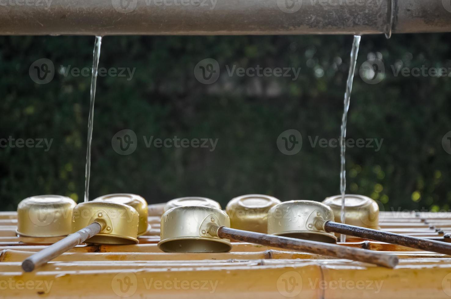 Japanese sacred ladles and holy water in local shrine in Kyoto photo