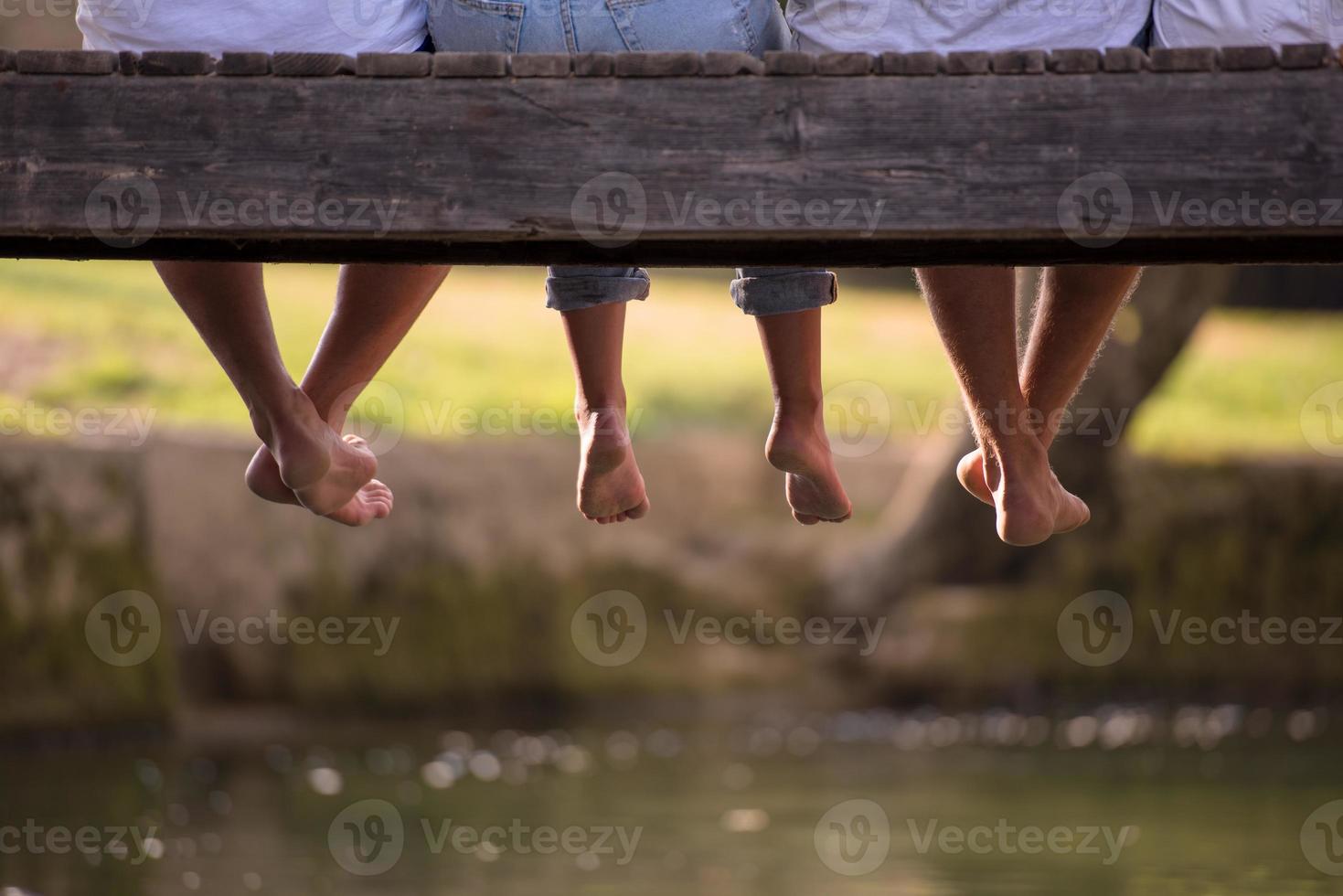 people sitting at wooden bridge photo