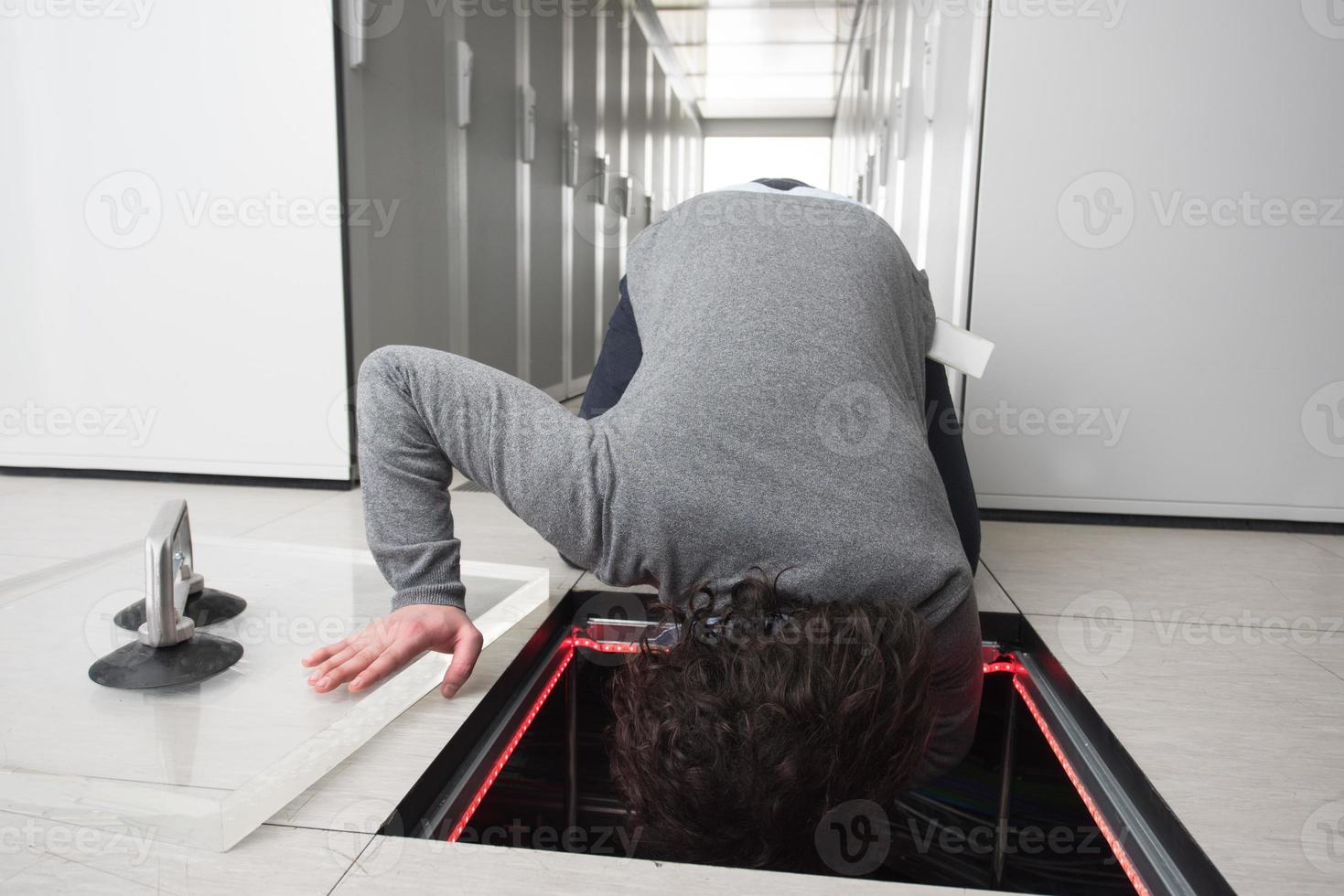 engineer connecting cables in server room photo