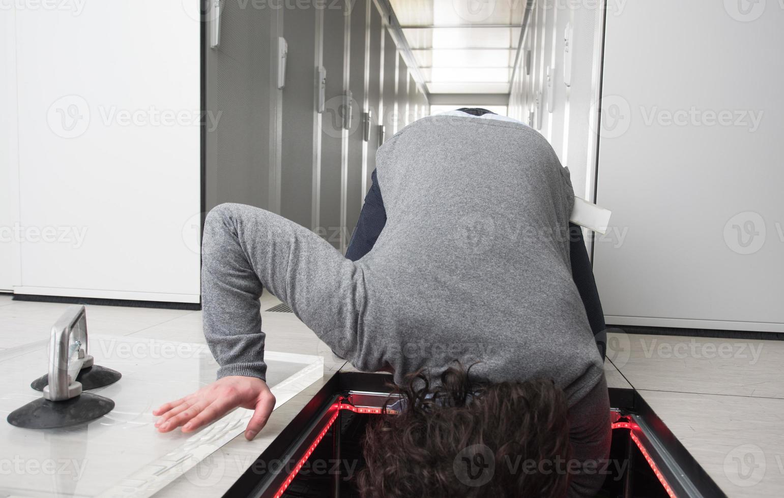 engineer connecting cables in server room photo