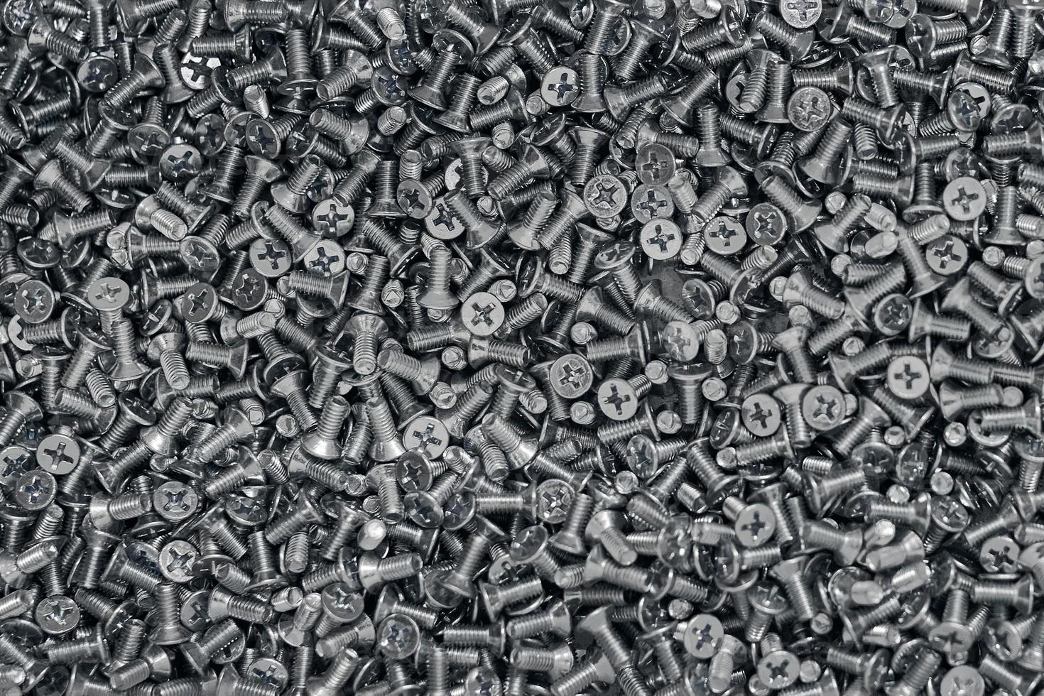 Bunch of galvanized stainless bolts with flat countersunk head, hardware background, silver screws photo