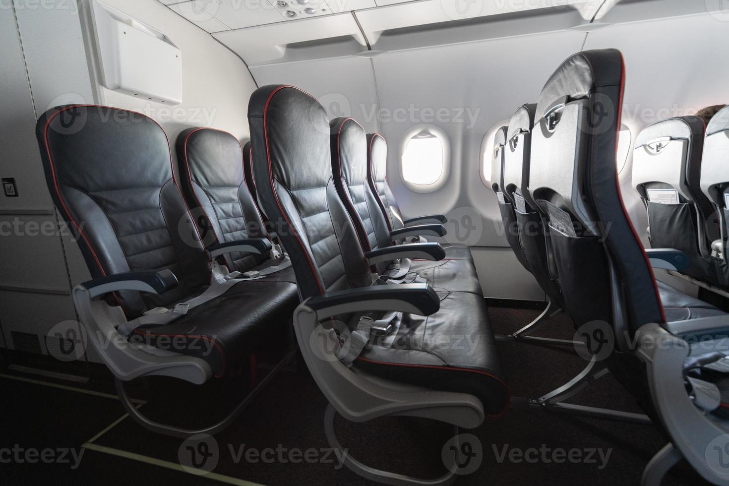 Airplane seats and windows. Economy class comfortable seats without passengers. New low-cost carrier airline photo