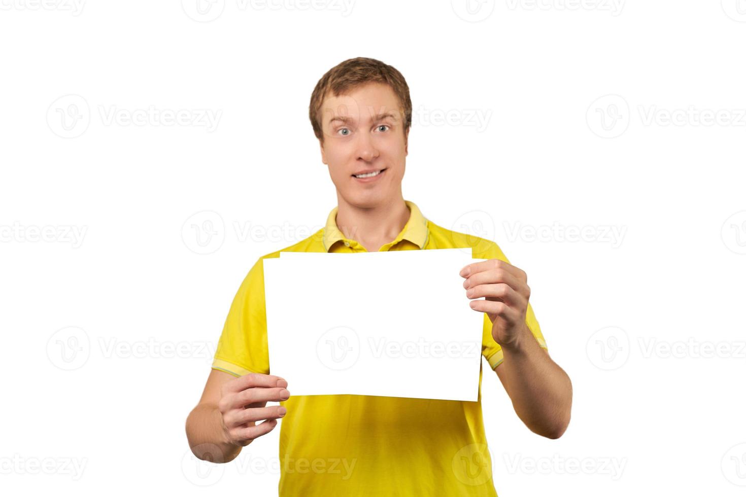 Funny attractive guy holding blank paper sheet, paper mockup isolated on white background photo