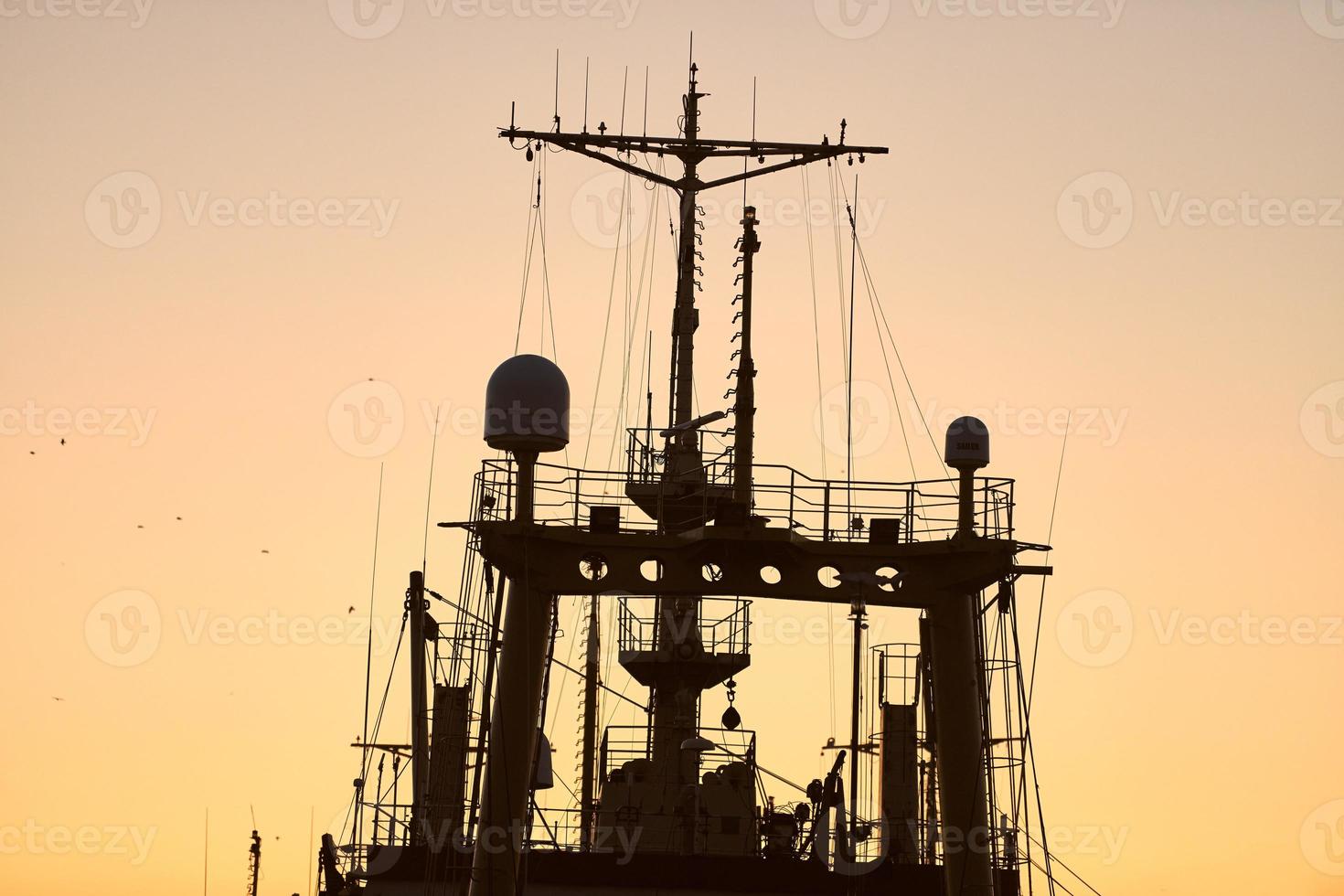 Silhouettes of ships and container cranes in sea port photo