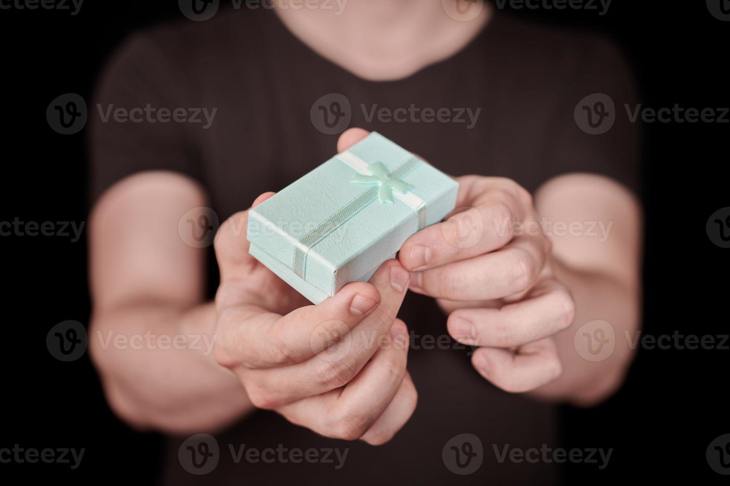 Gift box in hand on St. Valentine day photo