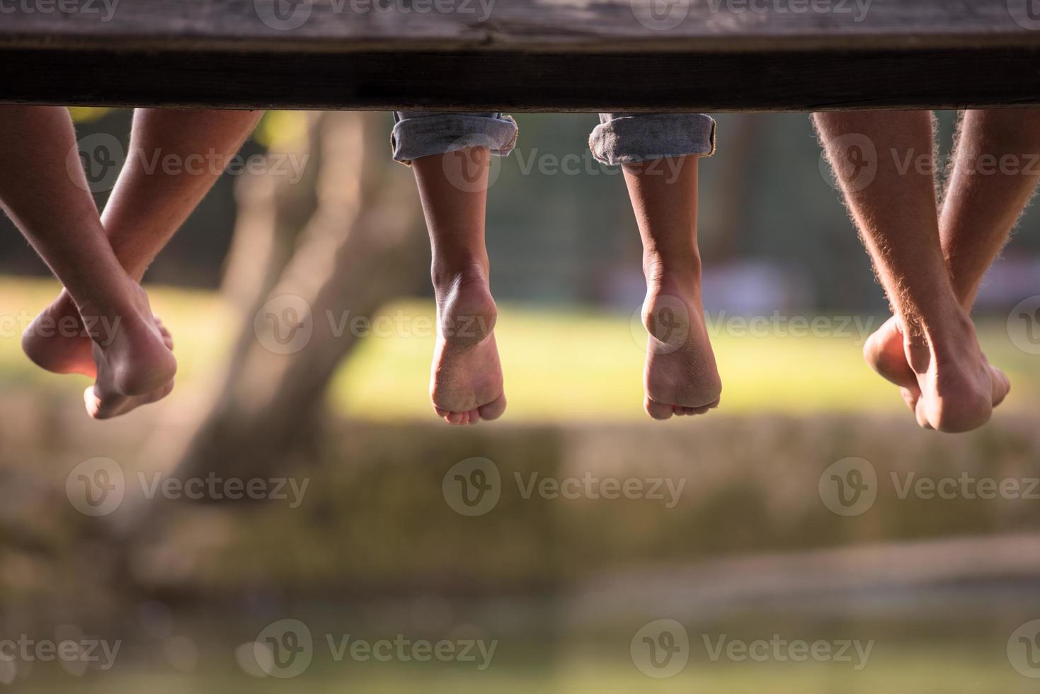 people sitting at wooden bridge photo