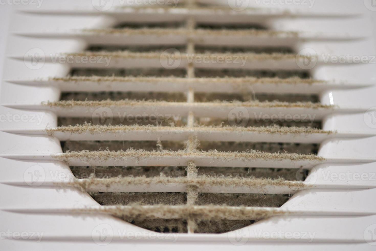 Dirty air ventilation grill of HVAC with clogged filter. photo