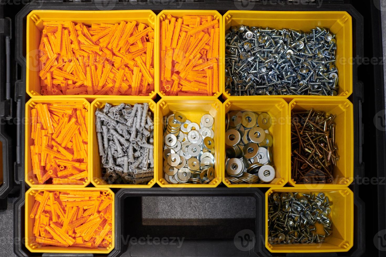 Storage case with screws, nuts, bolts, nails and other small tools for repairer, top view photo