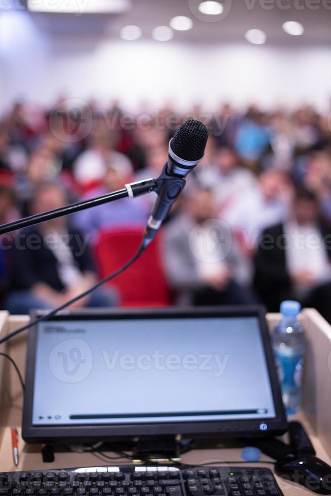 laptop computer and microphone at podium photo