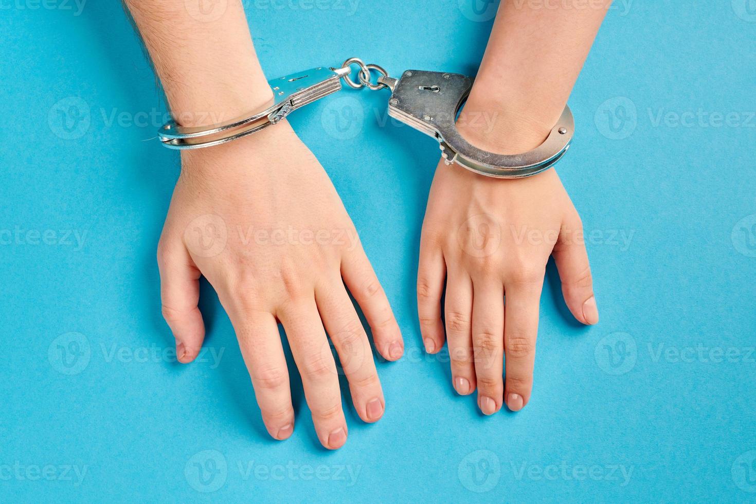 Male and female hands in handcuffs. Love forever. photo