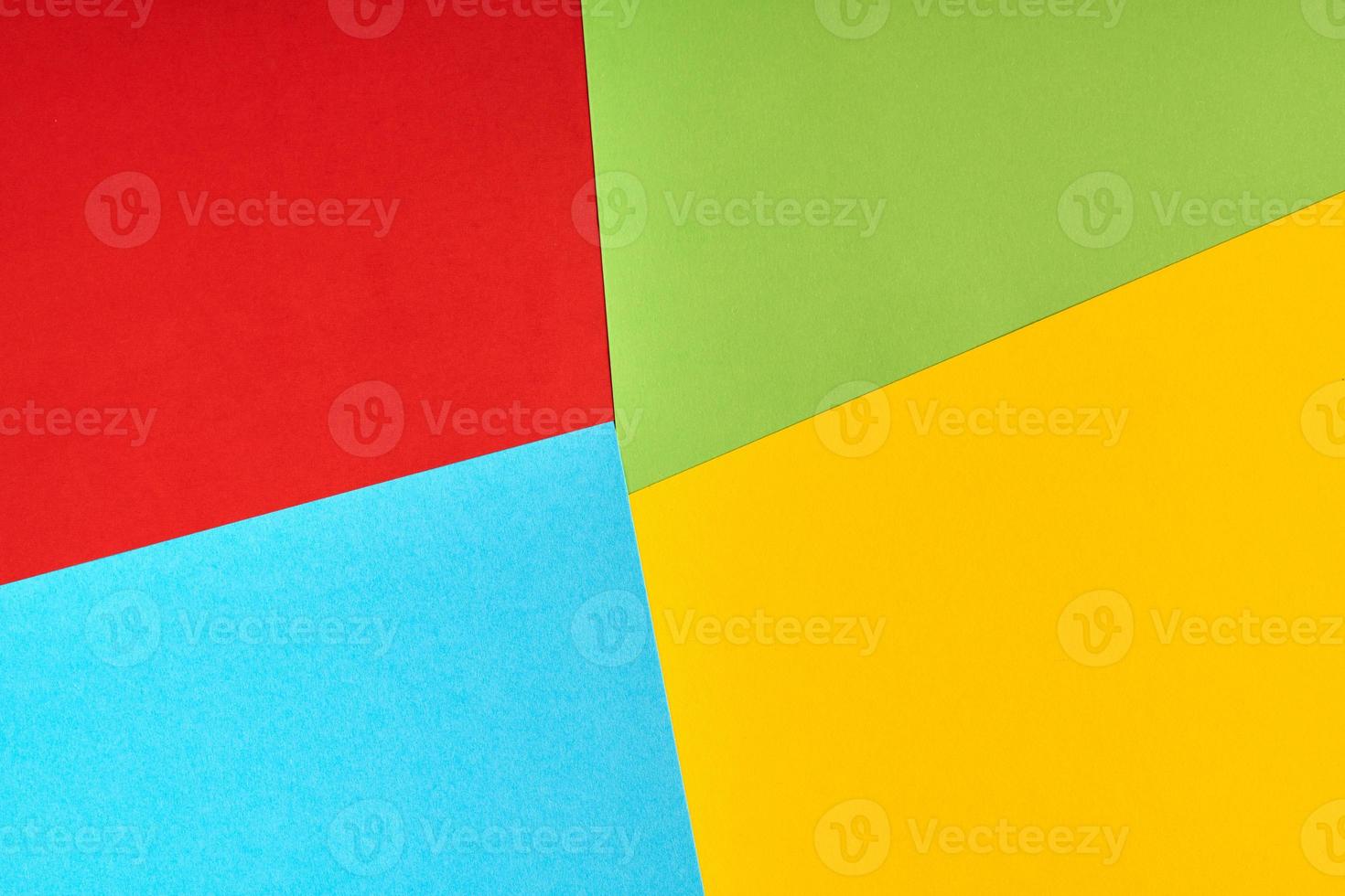 Red, green, blue, yellow paper colours. Corporation logo concept. photo