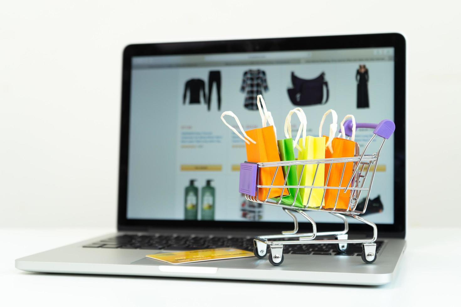 Online shopping or ecommmerce delivery service concept,Paper box on a laptop computer ,Easy shopping online concept photo