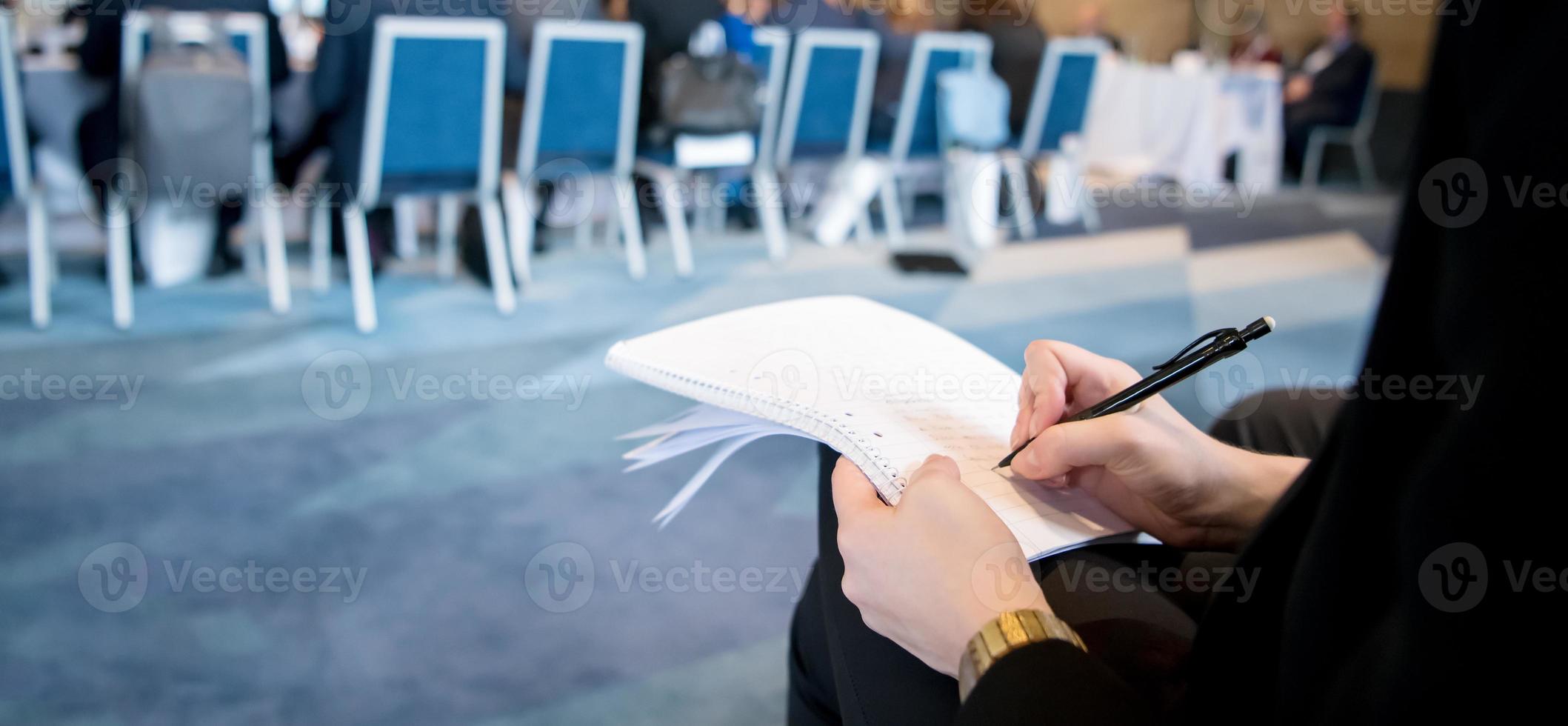 close up of business people taking notes photo