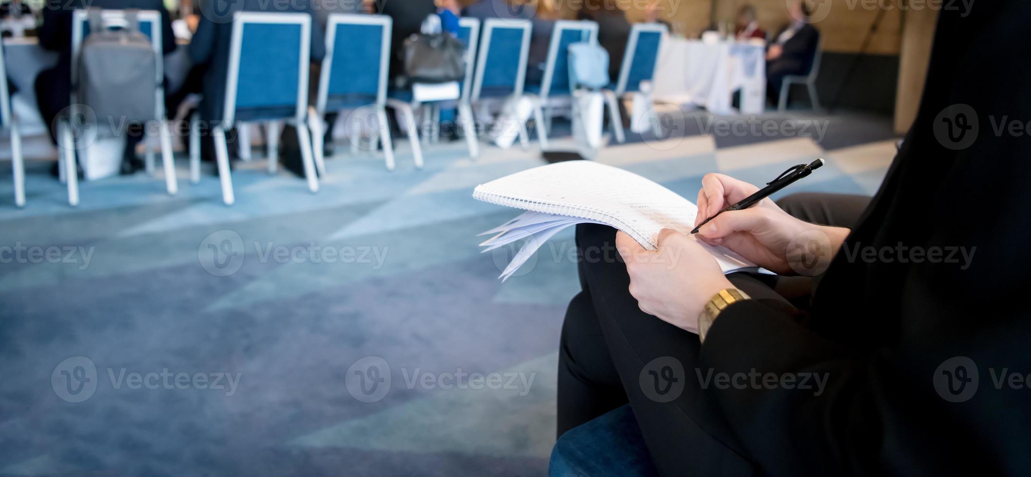 close up of business people taking notes photo