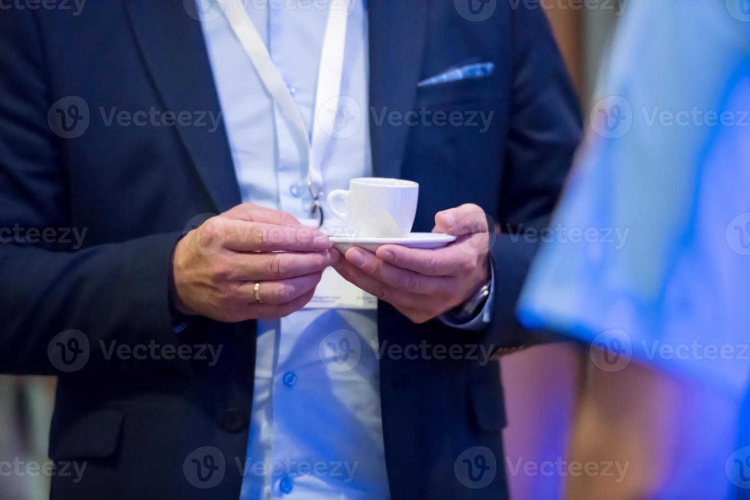 closeup of businessman holding a cup of coffee photo