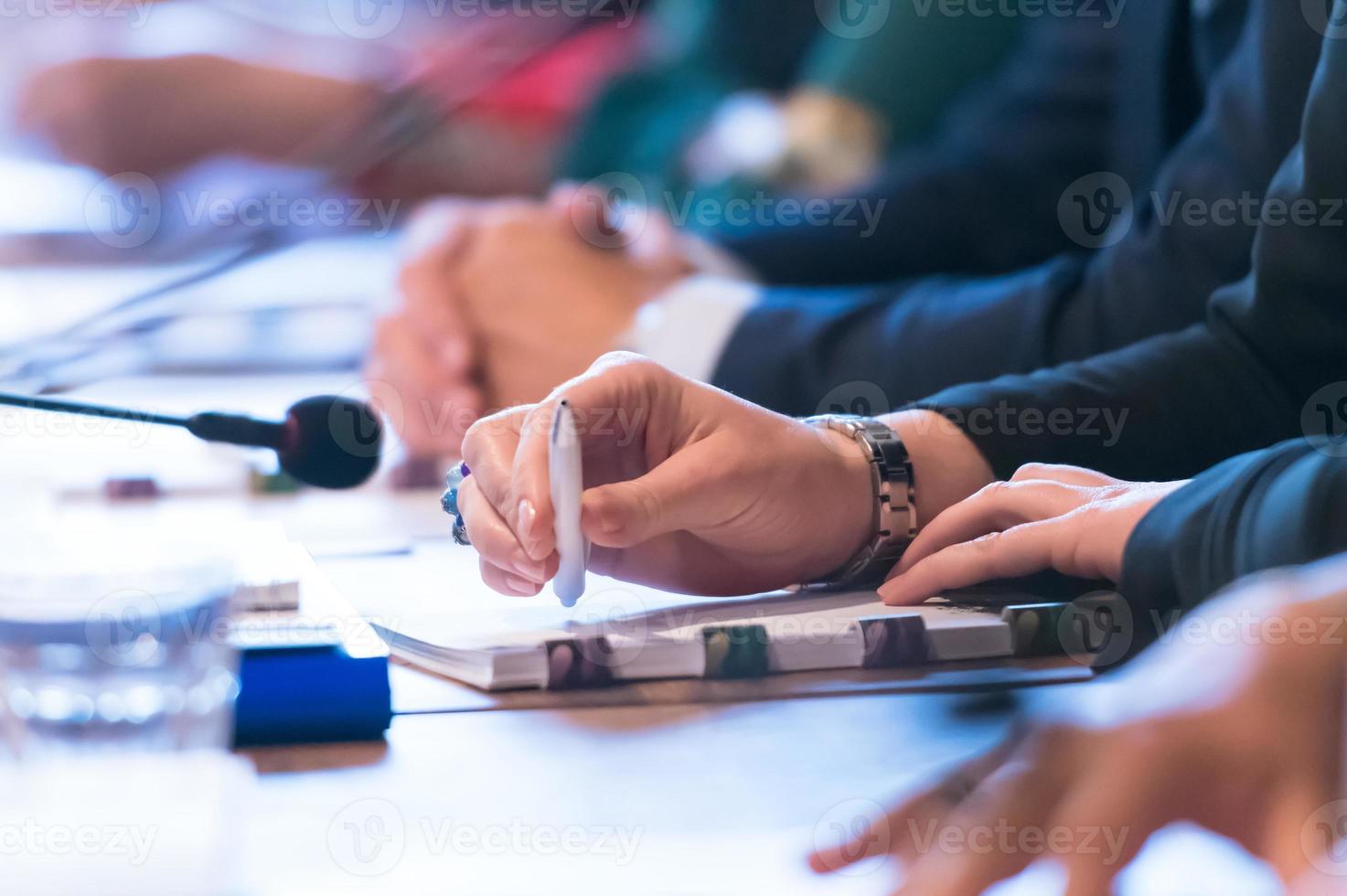 close up of business people taking notes photo