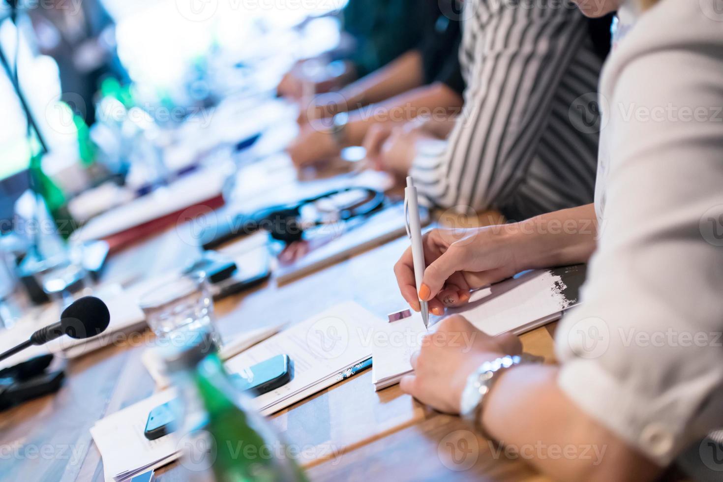 close up of business people taking notes photo
